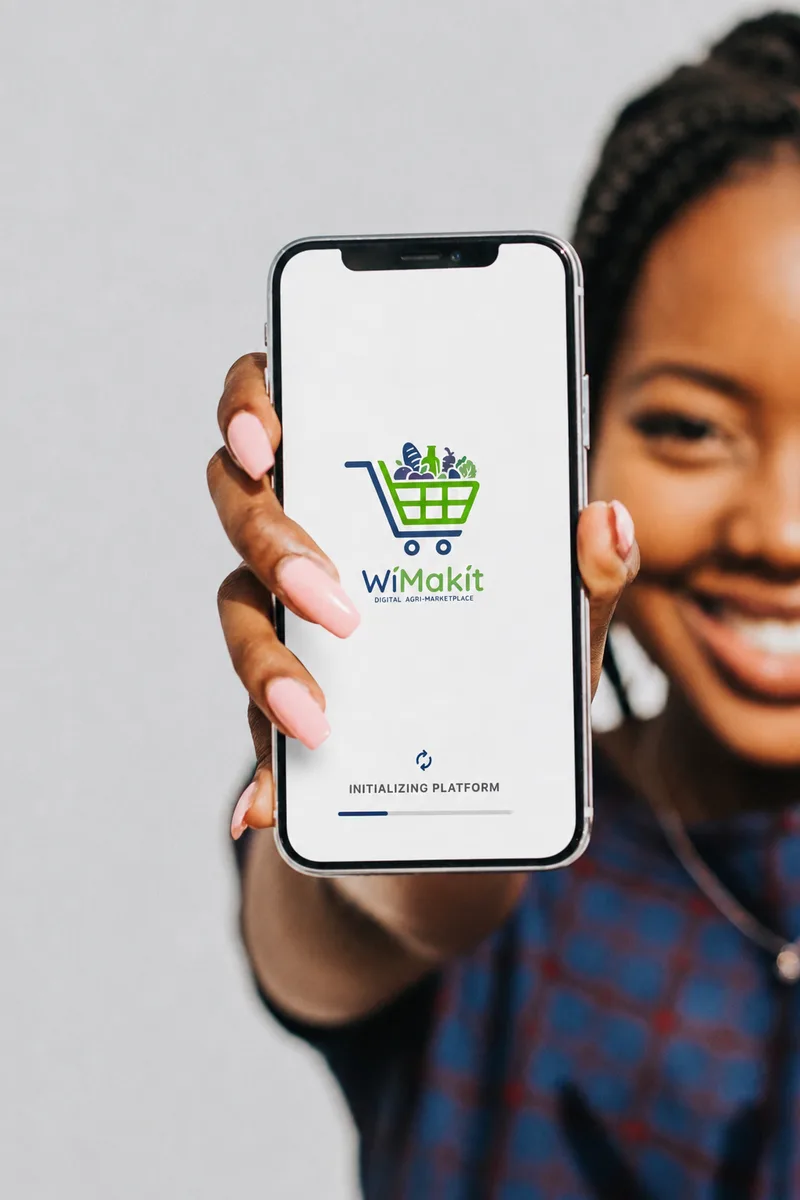 A WiMakit buyer holding up her phone showing the app loading screen